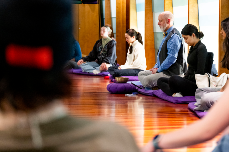 A group of students and faculty practice meditation during Health Week at Northeastern University