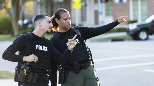 Two police officers patrol the community on foot
